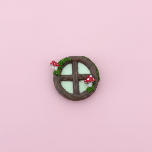 Fairy window with mushrooms figurine studio photo pink background